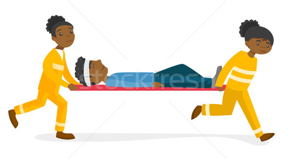Emergency doctors transporting man on stretcher. Stock photo © RAStudio