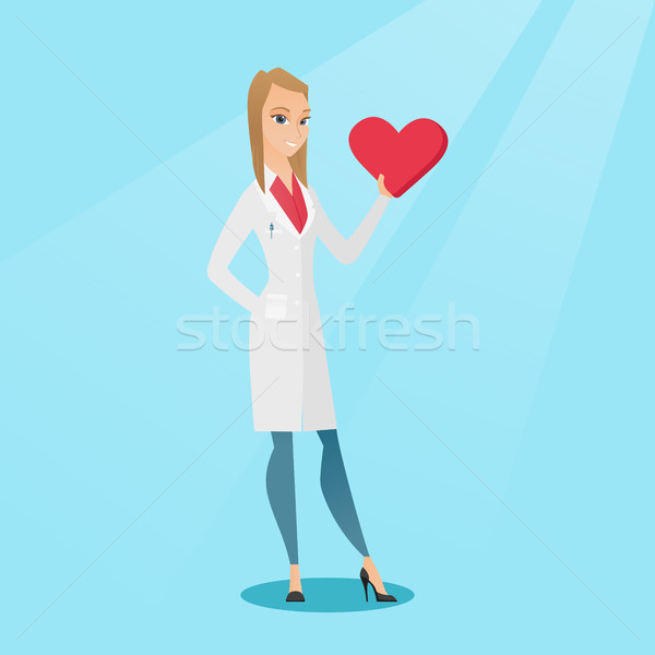 Doctor cardiologist holding heart. Stock photo © RAStudio