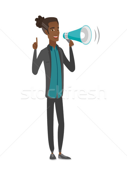 Young african businessman talking into loudspeaker Stock photo © RAStudio