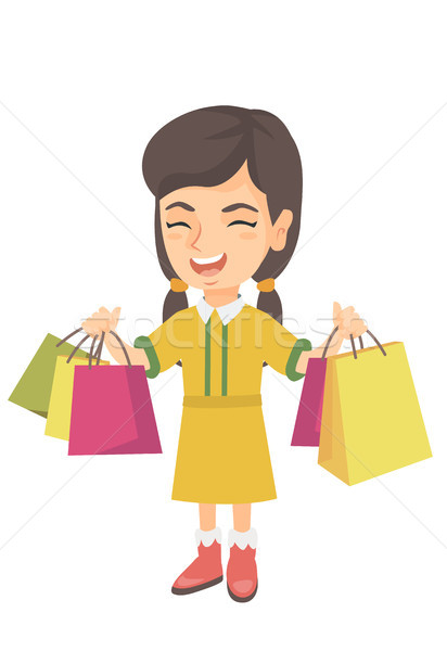 Happy caucasian girl holding shopping bags. Stock photo © RAStudio