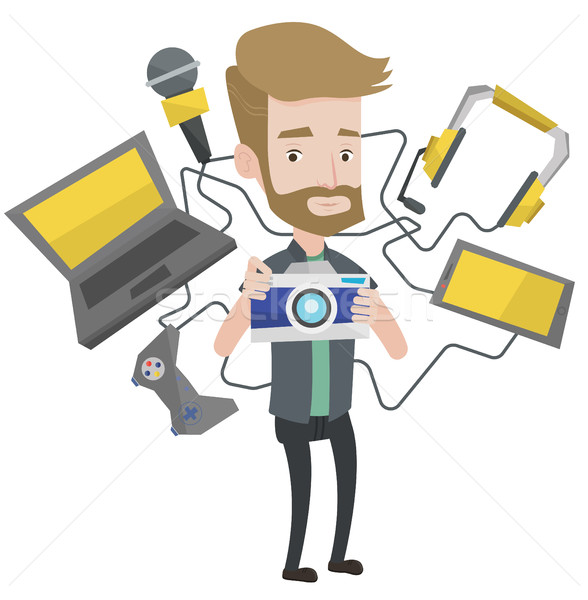 Young man surrounded with his gadgets. Stock photo © RAStudio