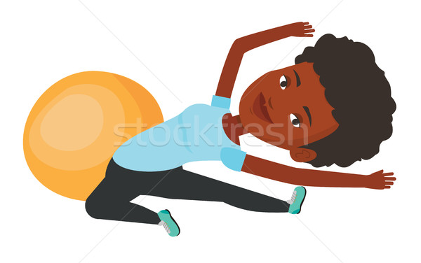 Young woman exercising with fitball. Stock photo © RAStudio