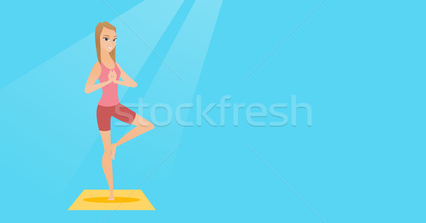 Young woman practicing yoga tree pose. Stock photo © RAStudio