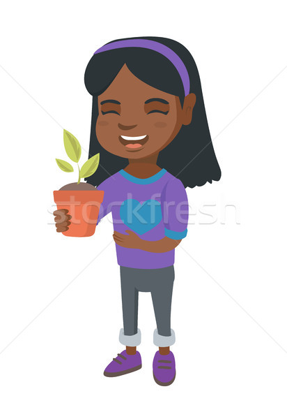 African smiling girl holding a potted plant. Stock photo © RAStudio