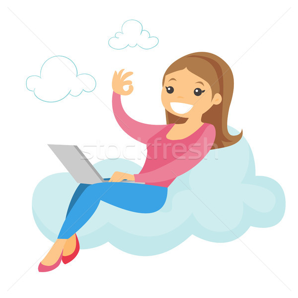 A woman on a cloud working on a laptop and showing ok sign. Stock photo © RAStudio