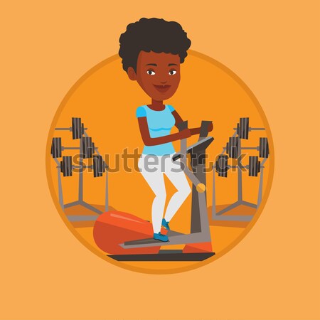 Woman exercising on elliptical trainer. Stock photo © RAStudio