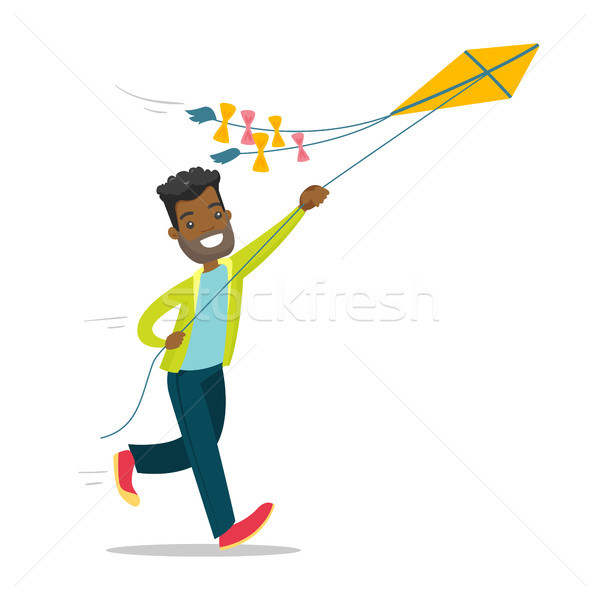 Young african-american man flying a kite. Stock photo © RAStudio