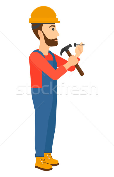 Stock photo: Man hammering nail.