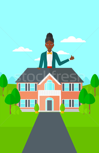 Agent immobilier pouce up permanent derrière [[stock_photo]] © RAStudio