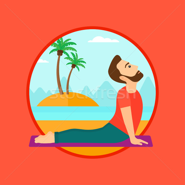 Man practicing yoga upward dog pose on the beach. Stock photo © RAStudio