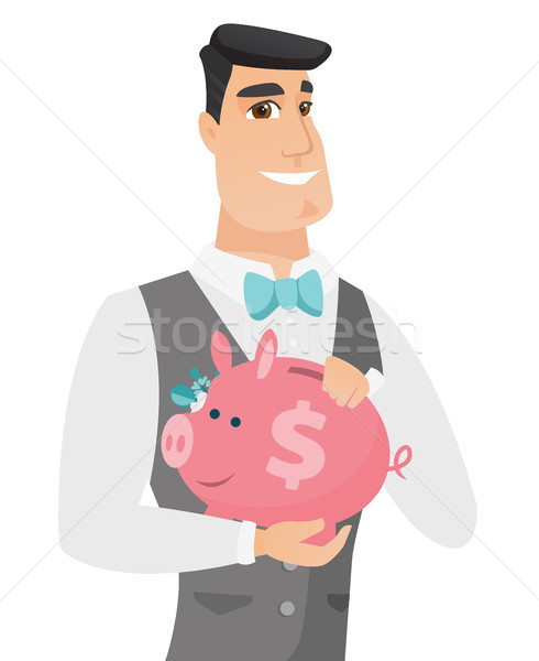Caucasian groom holding a piggy bank. Stock photo © RAStudio