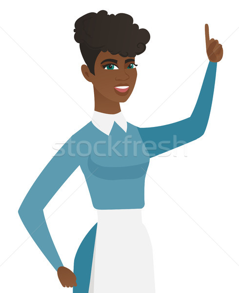 Young african cleaner pointing her forefinger up. Stock photo © RAStudio
