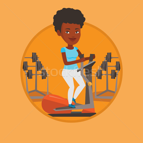 Woman exercising on elliptical trainer. Stock photo © RAStudio