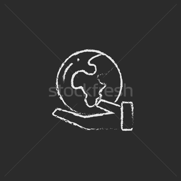 Hand holding the Earth icon drawn in chalk. Stock photo © RAStudio