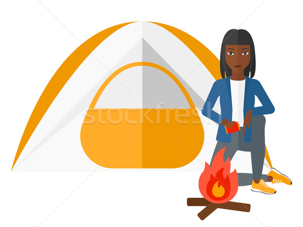 Woman kindling fire. Stock photo © RAStudio