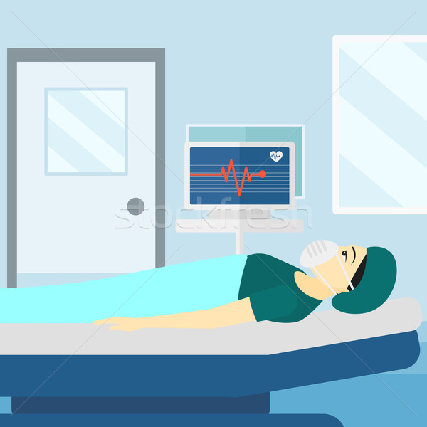 Patient lying in hospital bed with heart monitor. Stock photo © RAStudio