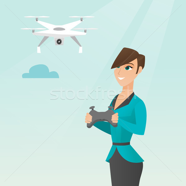 Young caucasian woman flying drone. Stock photo © RAStudio