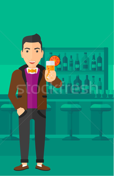 Stock photo: Man holding glass of juice.