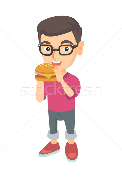 Caucazian băiat mananca hamburger apetit Imagine de stoc © RAStudio