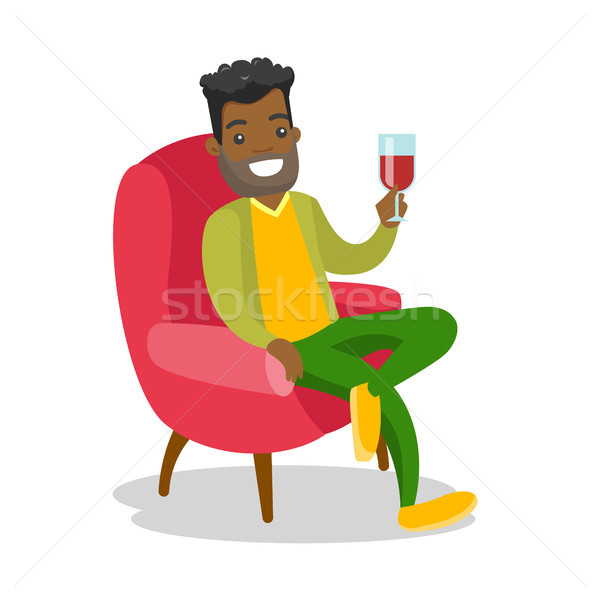 African-american man drinking wine in the chair. Stock photo © RAStudio