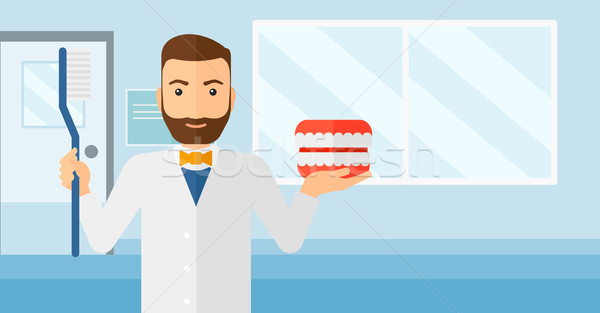 Dentist with dental jaw model and toothbrush. Stock photo © RAStudio