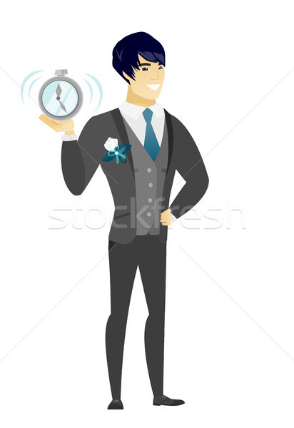 Asian groom holding alarm clock. Stock photo © RAStudio