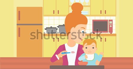 Woman feeding baby. Stock photo © RAStudio