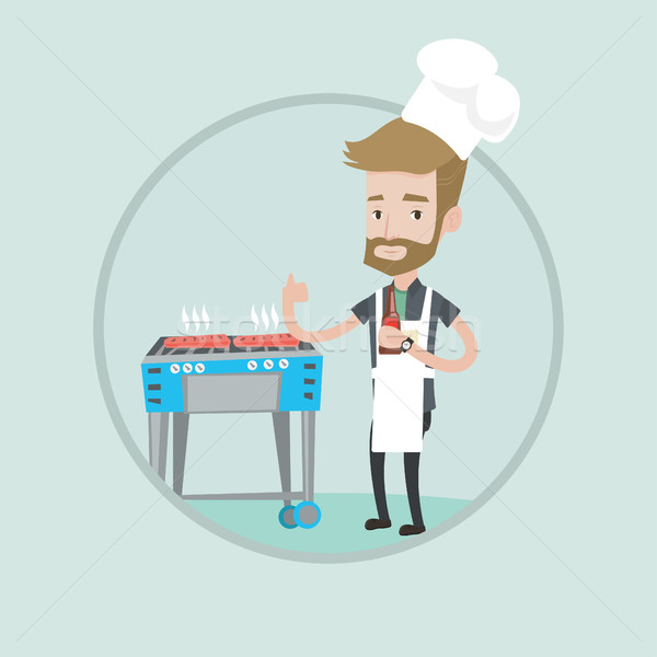 Man cooking steak on gas barbecue grill. Stock photo © RAStudio