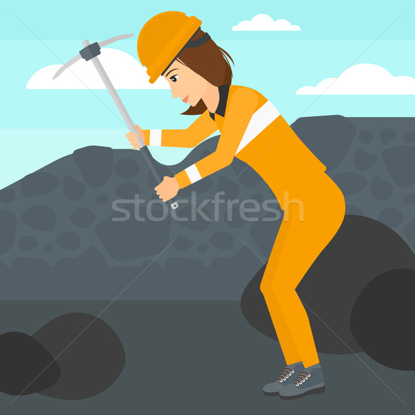 Stock photo: Miner working with pick.