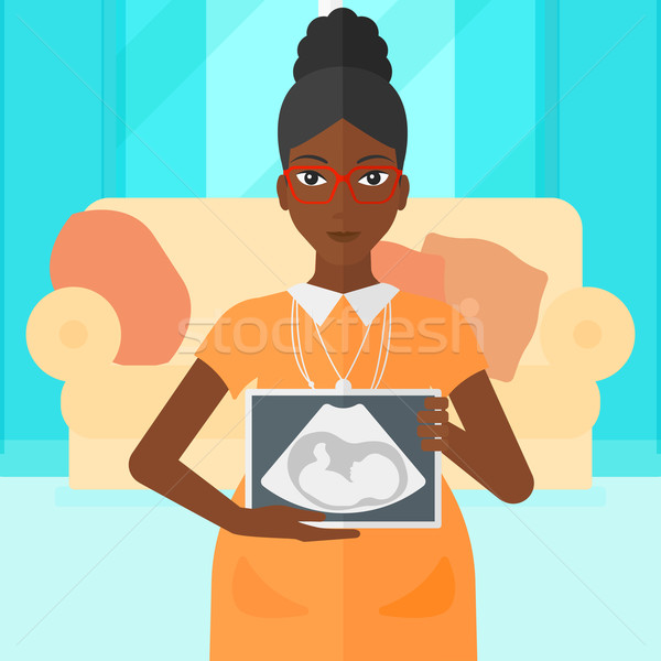 Pregnant woman with ultrasound image. Stock photo © RAStudio