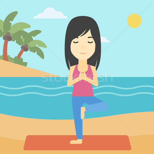 Woman practicing yoga tree pose on the beach. Stock photo © RAStudio