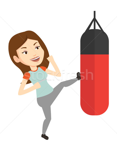 Woman exercising with punching bag. Stock photo © RAStudio