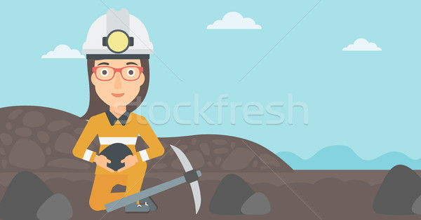 Miner holding coal in hands. Stock photo © RAStudio