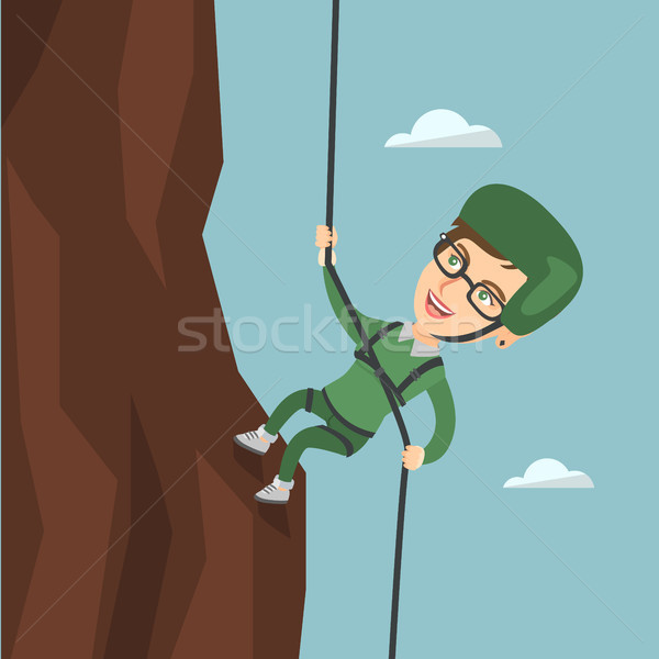 Caucasian woman climbing a mountain with rope. Stock photo © RAStudio