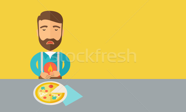 Man has a stomach burn or abdominal pain after he ate pizza. Stock photo © RAStudio