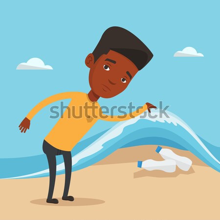 Man showing plastic bottles under sea wave. Stock photo © RAStudio