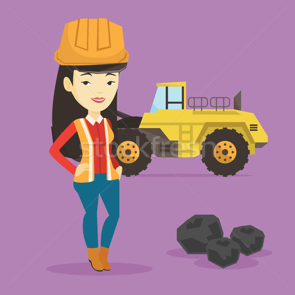 Stock photo: Miner with a big excavator on background.