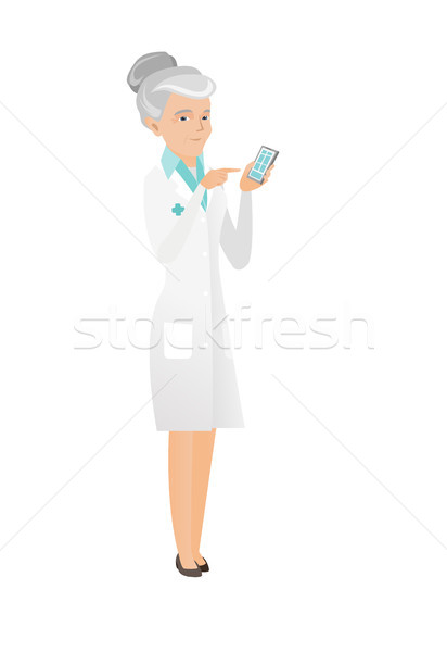 Senior caucasian doctor holding a mobile phone. Stock photo © RAStudio