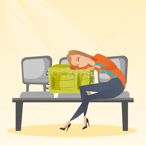 Tired woman sleeping on suitcase at the airport. Stock photo © RAStudio