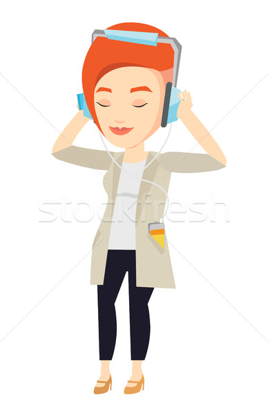 Stock photo: Young woman in headphones listening to music.