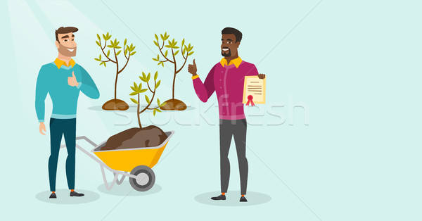 Two young multicultural men plant trees. Stock photo © RAStudio