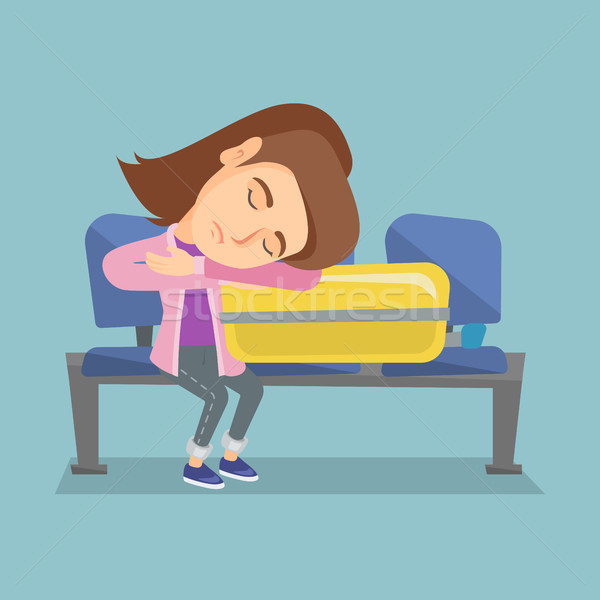 Tired woman sleeping on suitcase at the airport. Stock photo © RAStudio