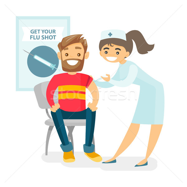 Doctor giving a free flu vaccination to a patient. Stock photo © RAStudio