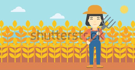 Stock photo: Farmer with pitchfork.