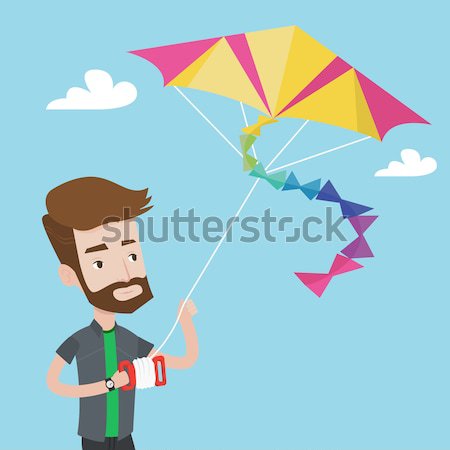 Young man flying kite vector illustration. Stock photo © RAStudio