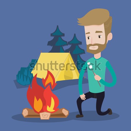 Businessman roasting marshmallow over campfire. Stock photo © RAStudio