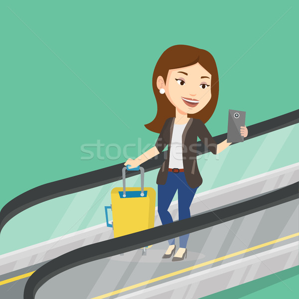 女性 スマートフォン エスカレーター 空港 立って スーツケース ストックフォト © RAStudio