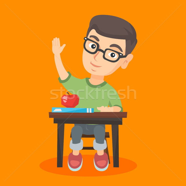 Schoolboy sitting at the desk with raised hand. Stock photo © RAStudio