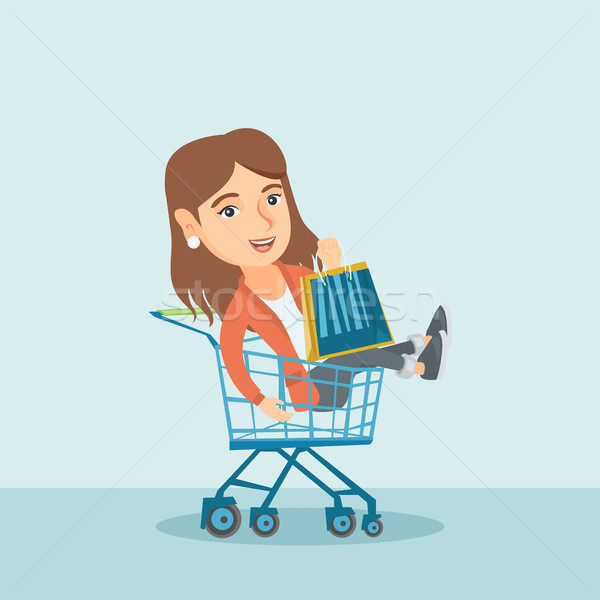 Young caucasian woman riding in shopping trolley. Stock photo © RAStudio