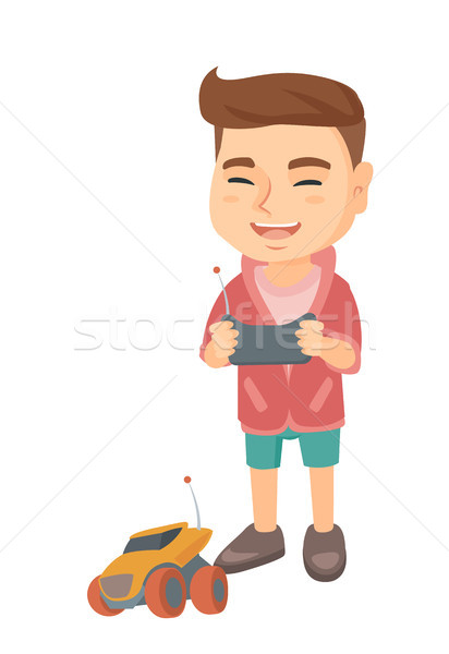 Caucasian boy playing with a radio-controlled car. Stock photo © RAStudio